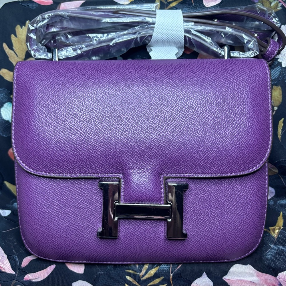 Purple shoulder bag with silver hardware. New.